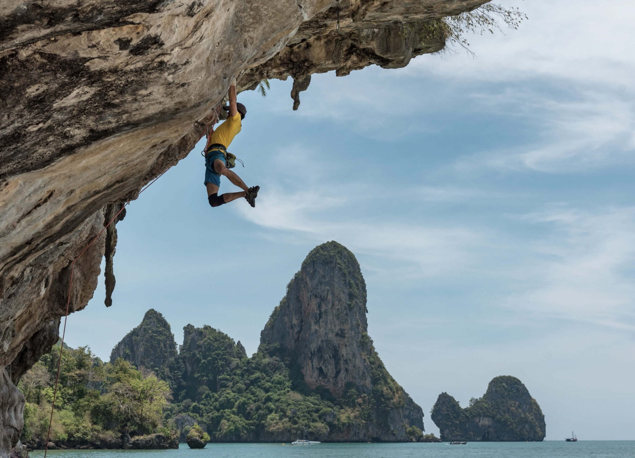 Rock climbing in Krabi, Thailand offers an exhilarating challenge on towering limestone cliffs with breathtaking views of turquoise waters and sandy beaches 